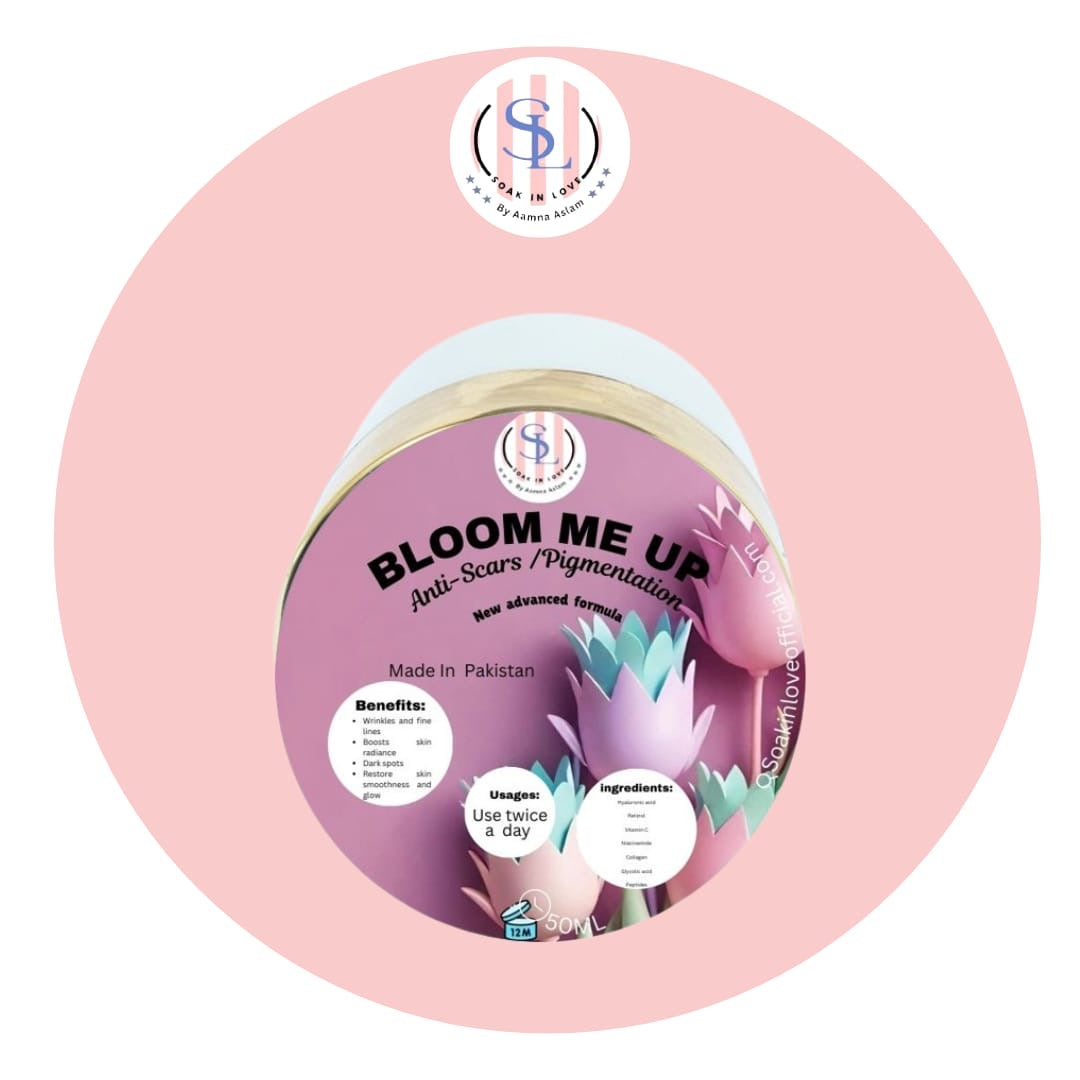 Round container featuring lotus flower design, branded as Bloom Me Up by Soak in Love for anti-scars and dark spots. Enriched with hyaluronic acid, made in Pakistan. Includes usage instructions: Use twice a day.