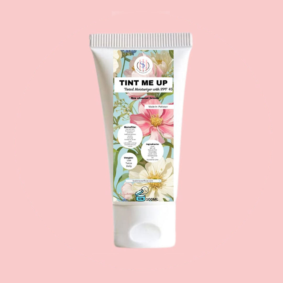 A tube of My Store's Tint Me Up tinted moisturizer with SPF 45, showcasing floral graphics against a pink background. This product merges the advantages of a BB cream, providing sun protection along with excellent coverage, hydration, and a matte finish. The tube indicates a size of 100 ml at the bottom.